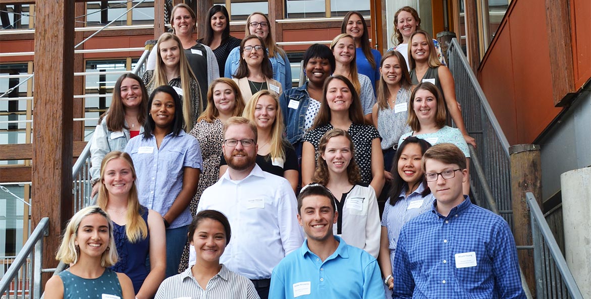 Twenty college students stand on the steps of CBF's Merrill Center.