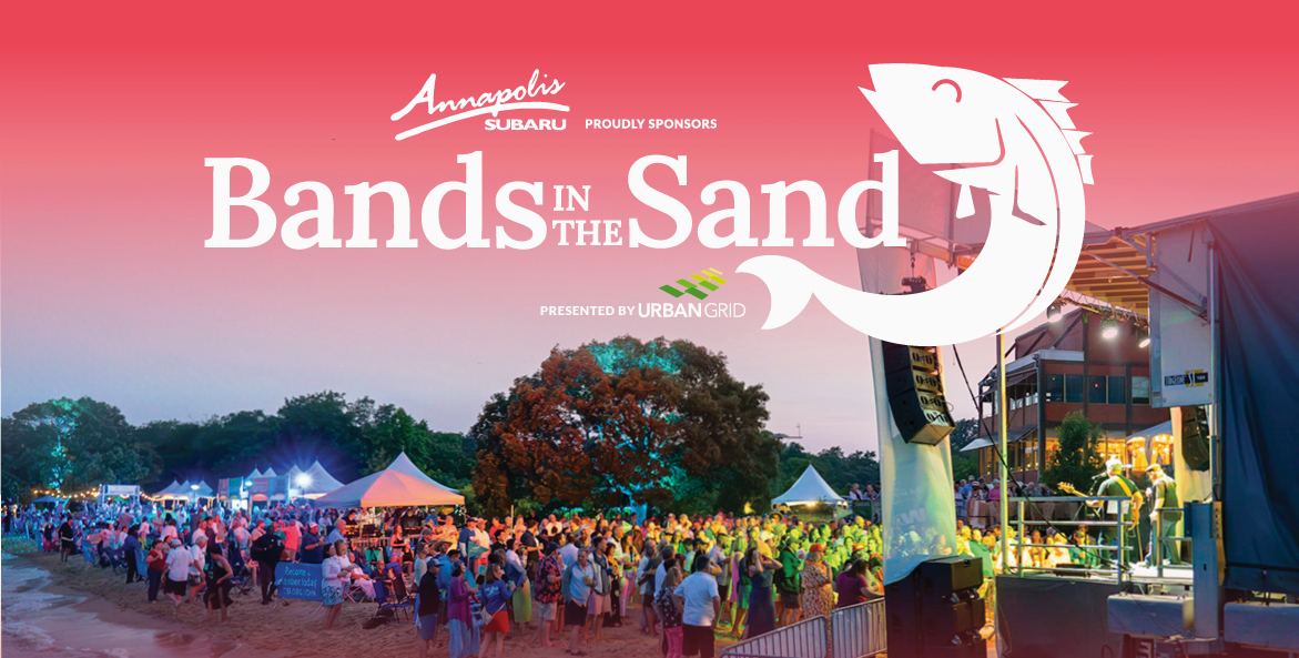Crowd on the beach and music stage during Bands in the Sand. Logo including Annapolis Subaru proudly presents Bands in the Sand.