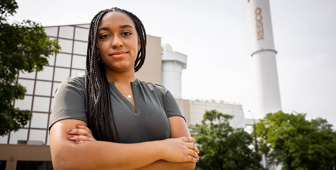 Taylor Lilley in front of the Wheelabrator trash incinerator in Baltimore, MD.