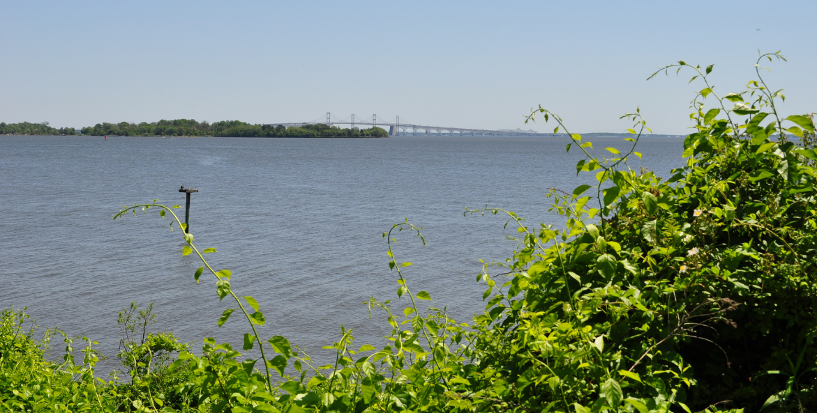 Water view of the Chesapeake Bay Brdge from along the shore at Greenbury Point in Annapolis, Maryland.