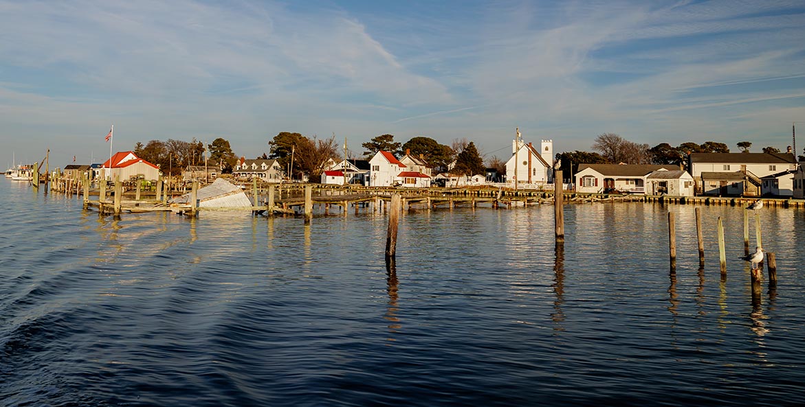 A view from the water of docks and houses.
