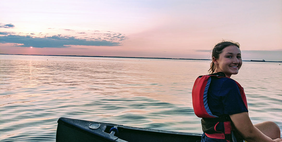 Girl sitting on a canoe