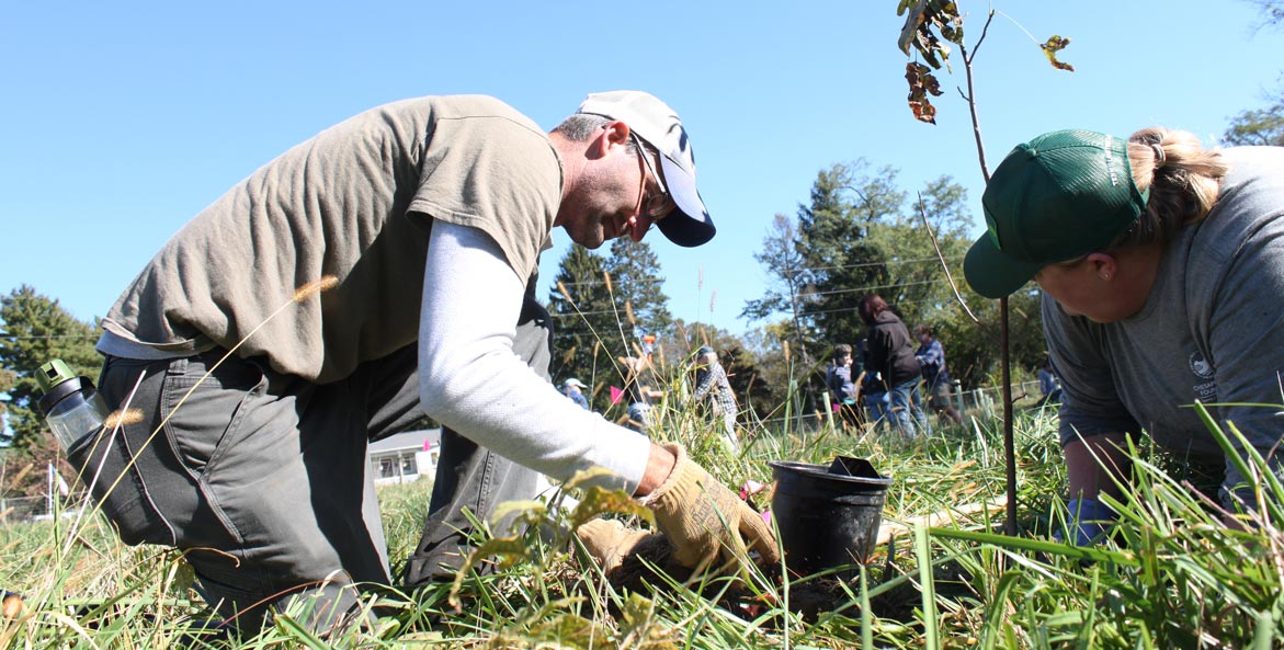 Nathan Drager works with CBF Keystone 10 Million Trees Partnership Manager Brenda Sieglitz to plant a tree on his farm in Marietta, Pennsylvania.