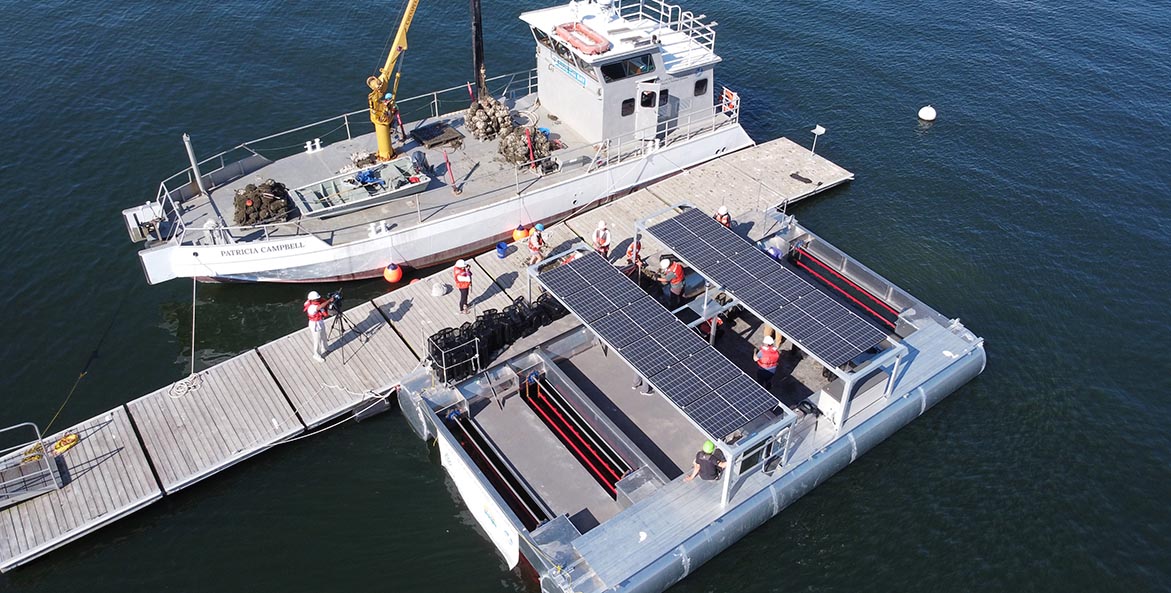 CBF's oyster restoration vessel Patricia Campbell is tied up to a floating dock across from the solar oyster platform.