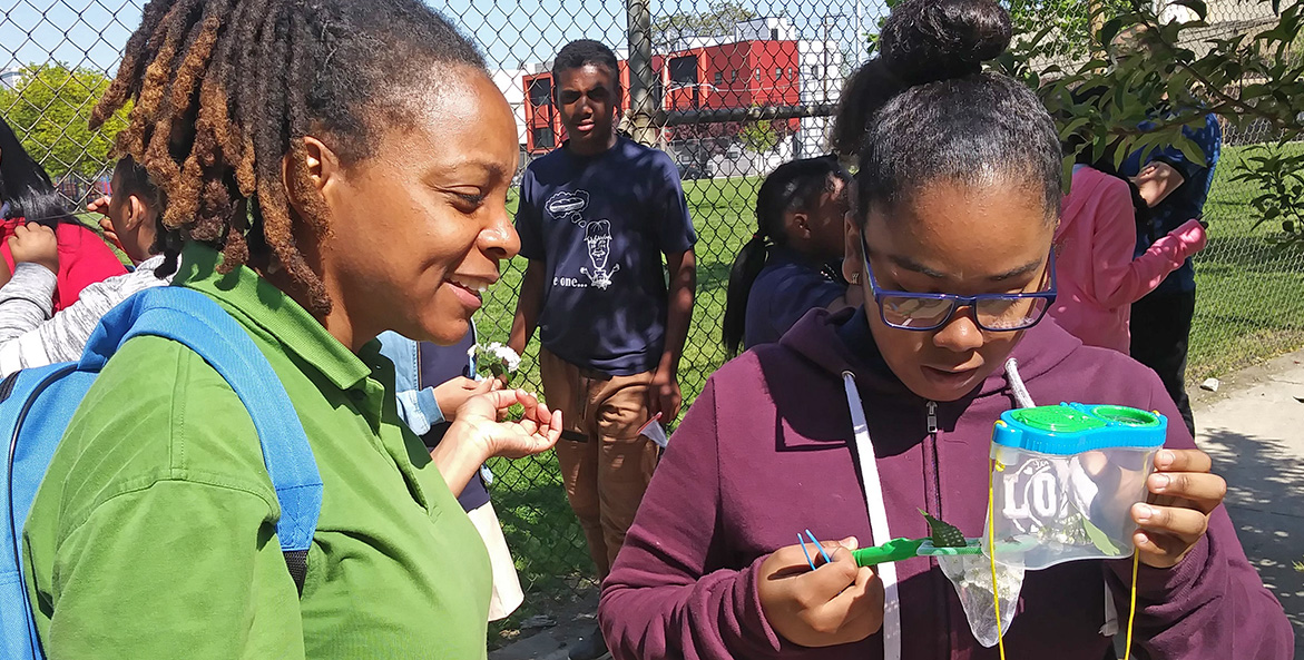 A student examines an insect.