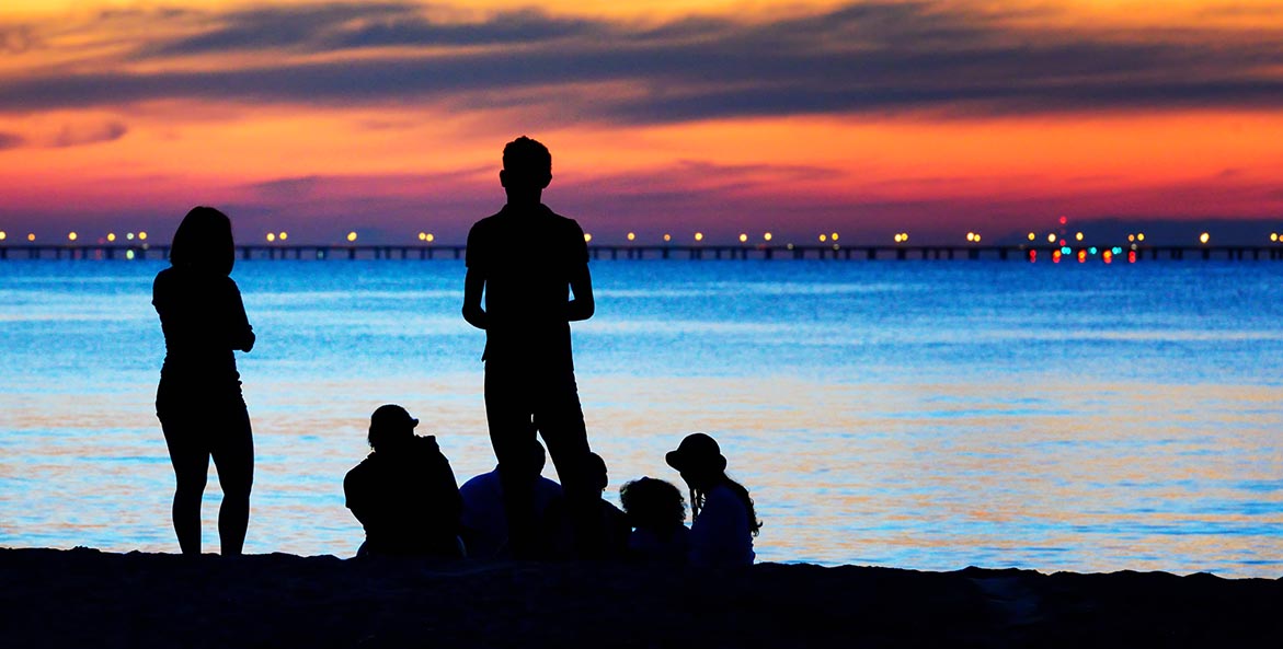 Thomas William family enjoying sunset 1171x593