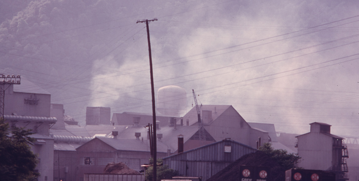 Pollution billows from a plant smokestack.
