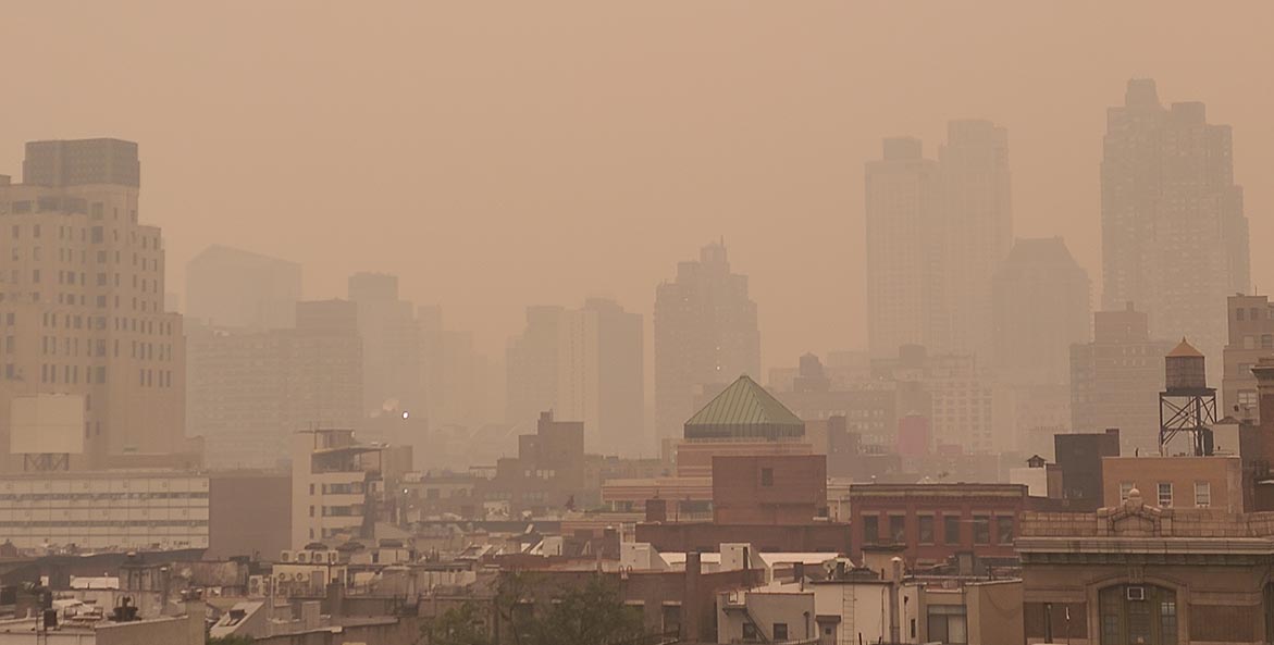 A heavy brown haze fills the skyline of New York City.