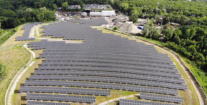 Rows of solar panels fill a 12-acre field.