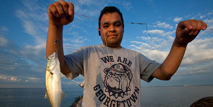 fisherman-shows-his-catch_Aigner_Rave-1724_695x352.jpg