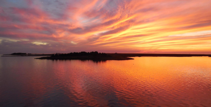 Image of a colorful sunset over the Bay.