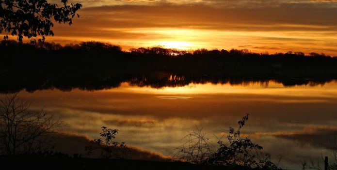 Image of an orange sunrise over the Wye River.
