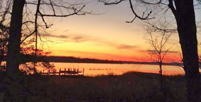 Image of a vibrant sunset over the West River.