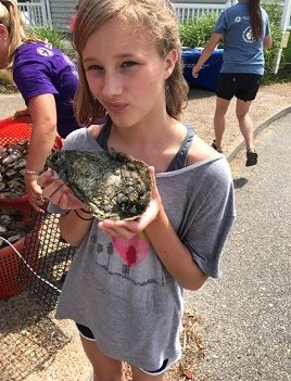 Eloise Caudle holds an oyster. 