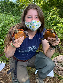 Picture of woman holding two turtles