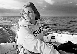 Carol Moore looks longingly at Tangier Island as she maneuvers her boat around the island.