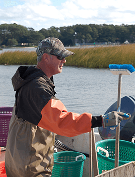 Chris Ludford stands in a boat on Virginia's Lynnhaven River.