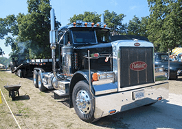 Closeup of a black Peterbuilt truck cab.