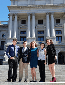 Five members of CBF's Student Leadership Council stand on the steps of the PA Capitol building.