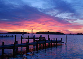A calming sunset settles over a dock on the waters of Sunset Point Cove off the Choptank River.