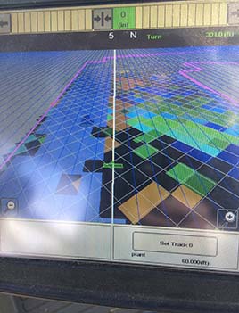 A close-up image of a controller screen for a tractor which dispenses fertilizer precisely. 