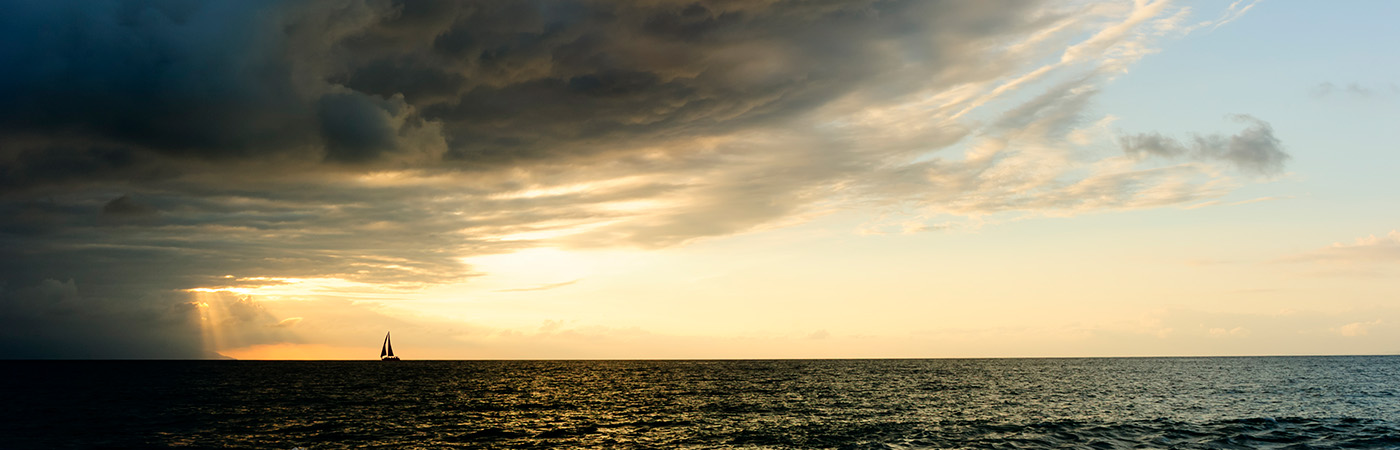 A storm overtakes a sailboat at sea.