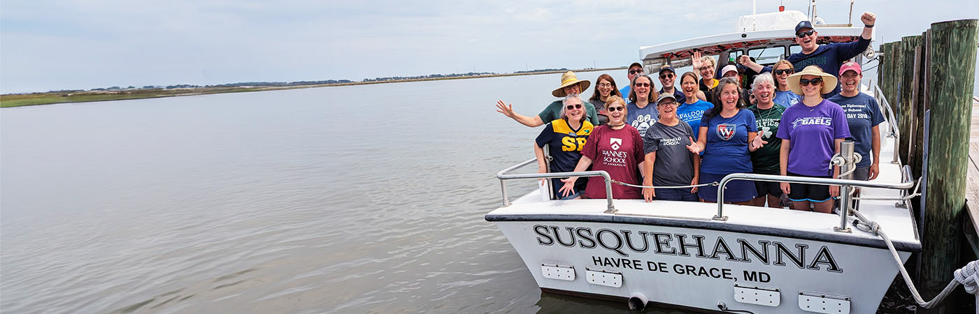 A group of teacher wave from the stern of CBF's education vessel, Susquehanna.