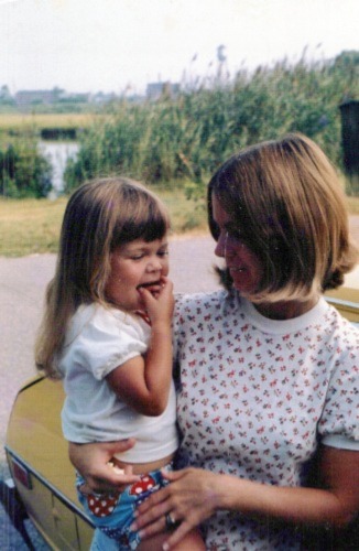 1970's era photo of a mother holding a toddler.