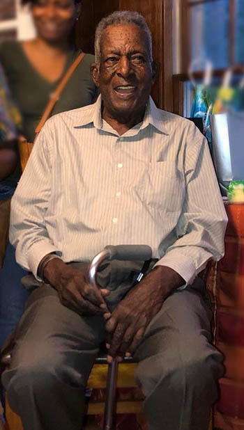 Man sitting in his chair at his birthday party. 