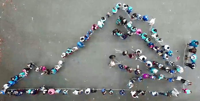 Students line up to form the boundary of the state of Virginia. 