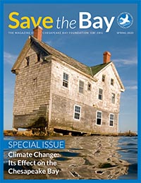 Magazine cover with photo of decrepit house completely surrounded by water.