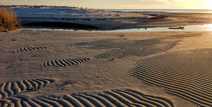 Photo of the patterns left in the sand after the tide water recede.