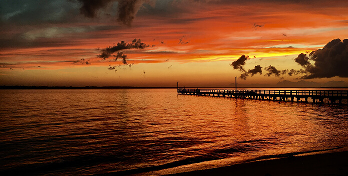 A vibrant orange sunset over the Rappahannock River.