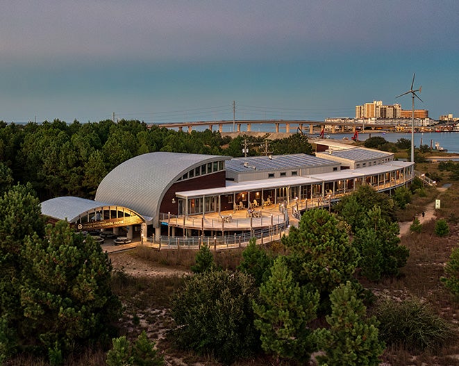 Lights illuminate the outside of the Brock Environmental Center at Twilight.