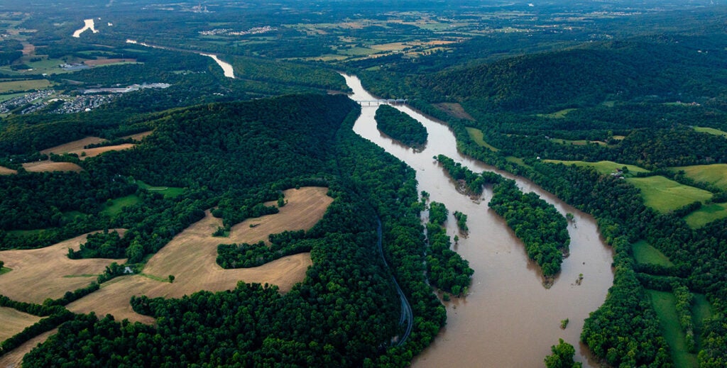 A river runs through forests and farmland.