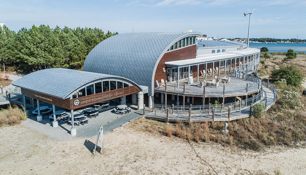 Aerial view of the Brock Environmental Center showing the curved roofs and round deck with the river in the background.