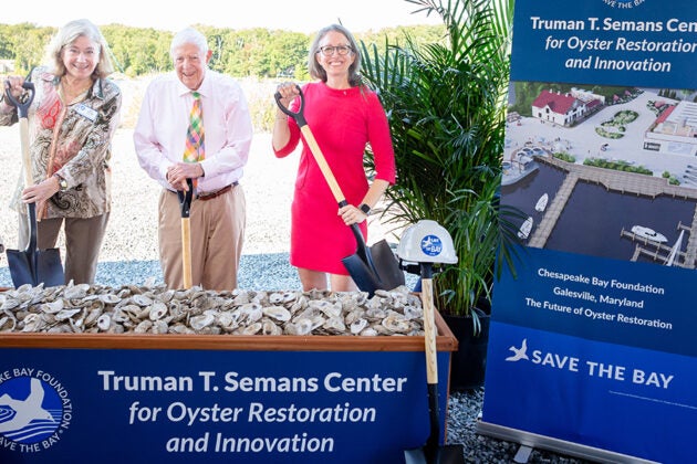 Three officials pose with ceremonial shovels at the groundbreaking ceremony for the Truman T. Semans Center for Oyster Restoration and Innovation.