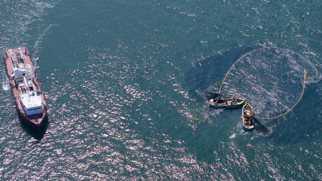 An aerial view of a boat purse seining menhaden.