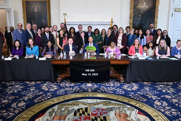 Officials and supporters gather for the signing of HB 506 in Maryland's State House on May 13, 2025.