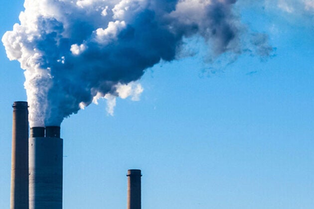 Steam billows from a power plant smokestack.