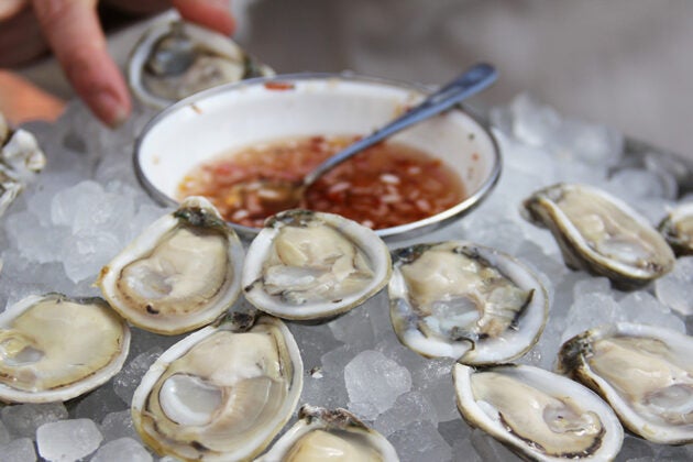 Oysters on the half shell sit on ice.