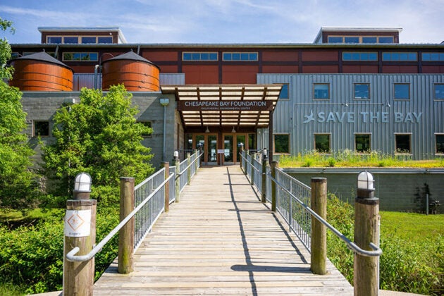 Building with sign over front doors reading Chesapeake Bay Foundation, with Save the Bay logo on the side of the building.