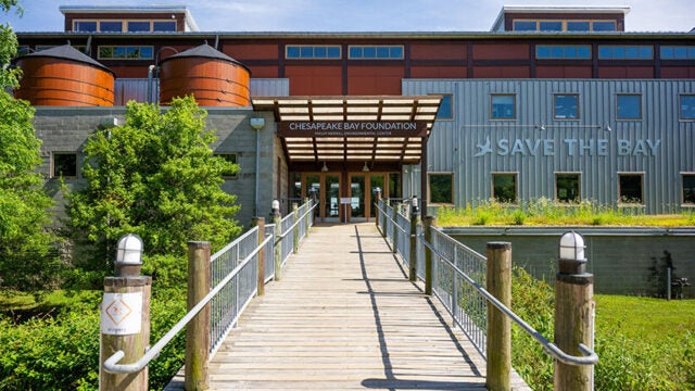 Building with sign over front doors reading Chesapeake Bay Foundation, with Save the Bay logo on the side of the building.