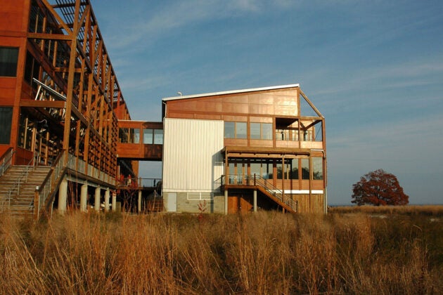 Side view of the back of CBF's Philip Merrill Environmental Center shows two connected buildings and louvers that overhang the exterior to provide shade.