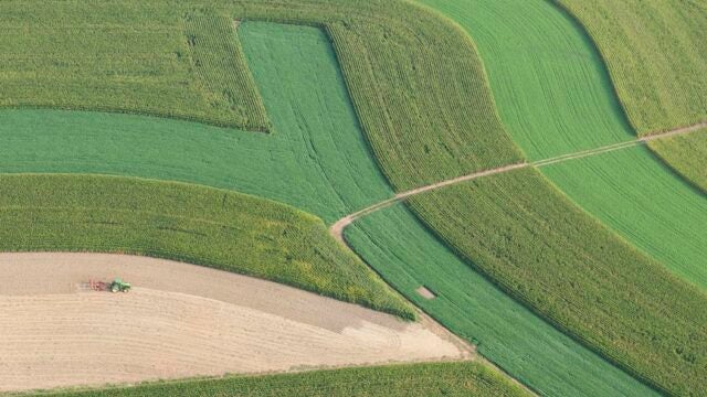 A tractor plows a field.