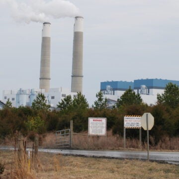Plumes of steam flow from towers at a coal-fired power plant.