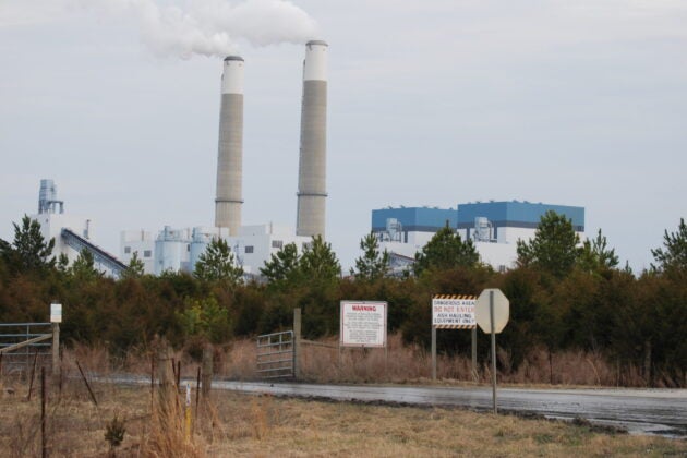 Plumes of steam flow from towers at a coal-fired power plant.