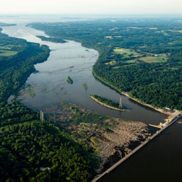 Aerial view of Conowingo Dam crossing the Susquehanna River, illustrating regional hydroelectric infrastructure and surrounding forested watershed.