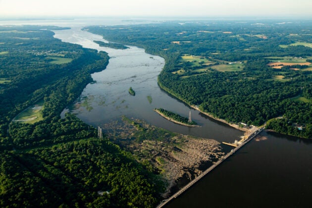 Aerial view of Conowingo Dam crossing the Susquehanna River, illustrating regional hydroelectric infrastructure and surrounding forested watershed.