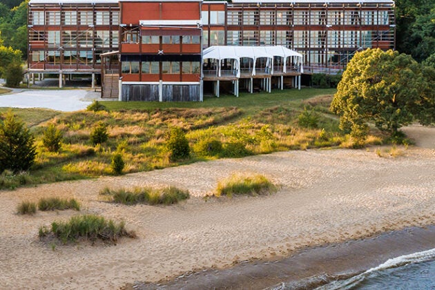 Waves lap the sandy beach at the Philip Merrill Environmental Center.